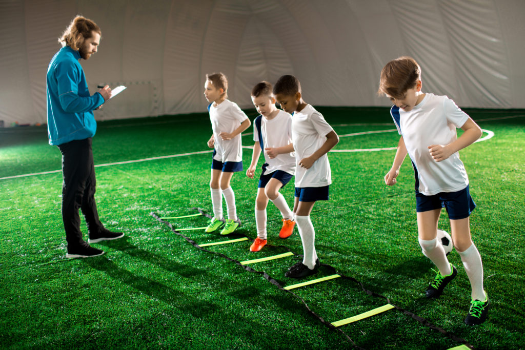 Young soccer players practicing at an indoor sports facility